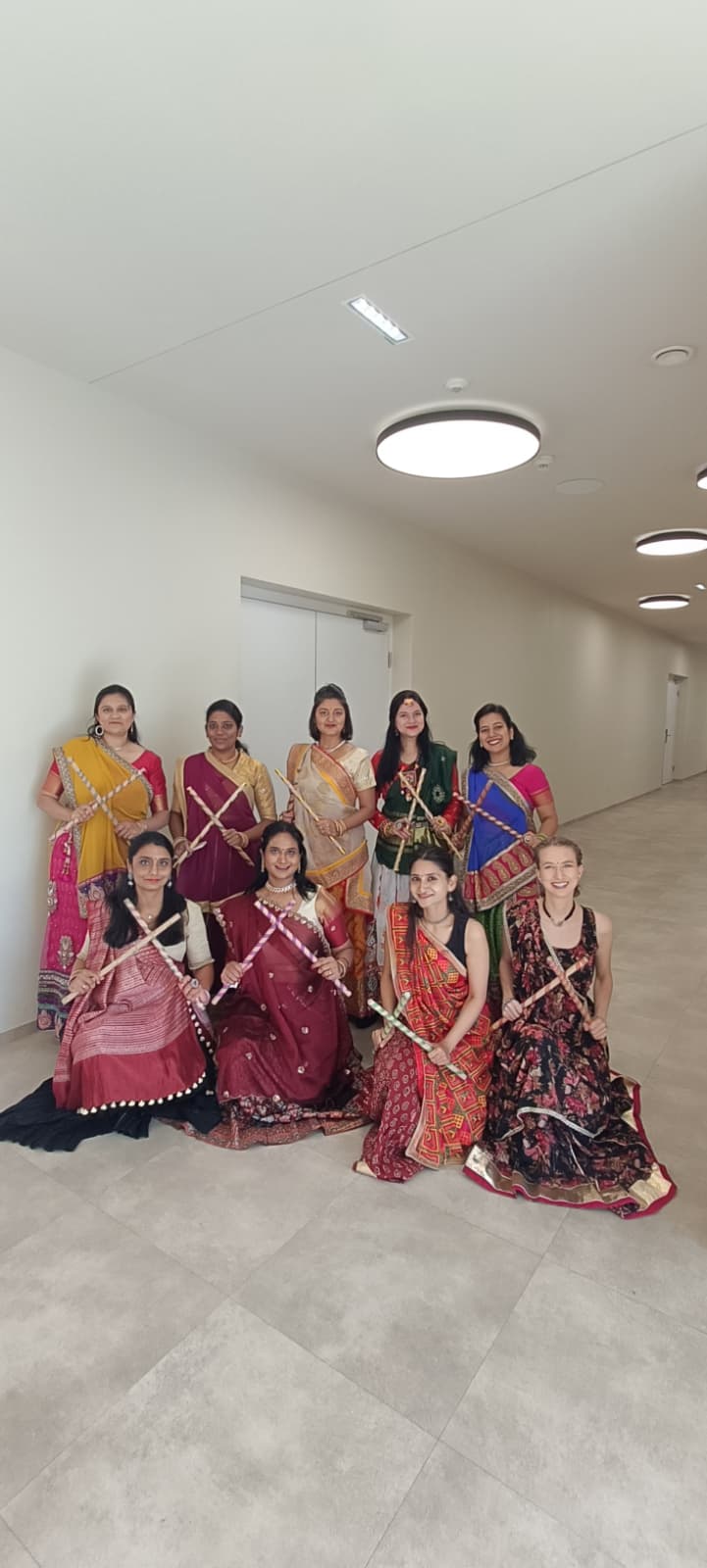 Dancers in traditional clothing perform with dandiya sticks at an Indian Independence Day event
