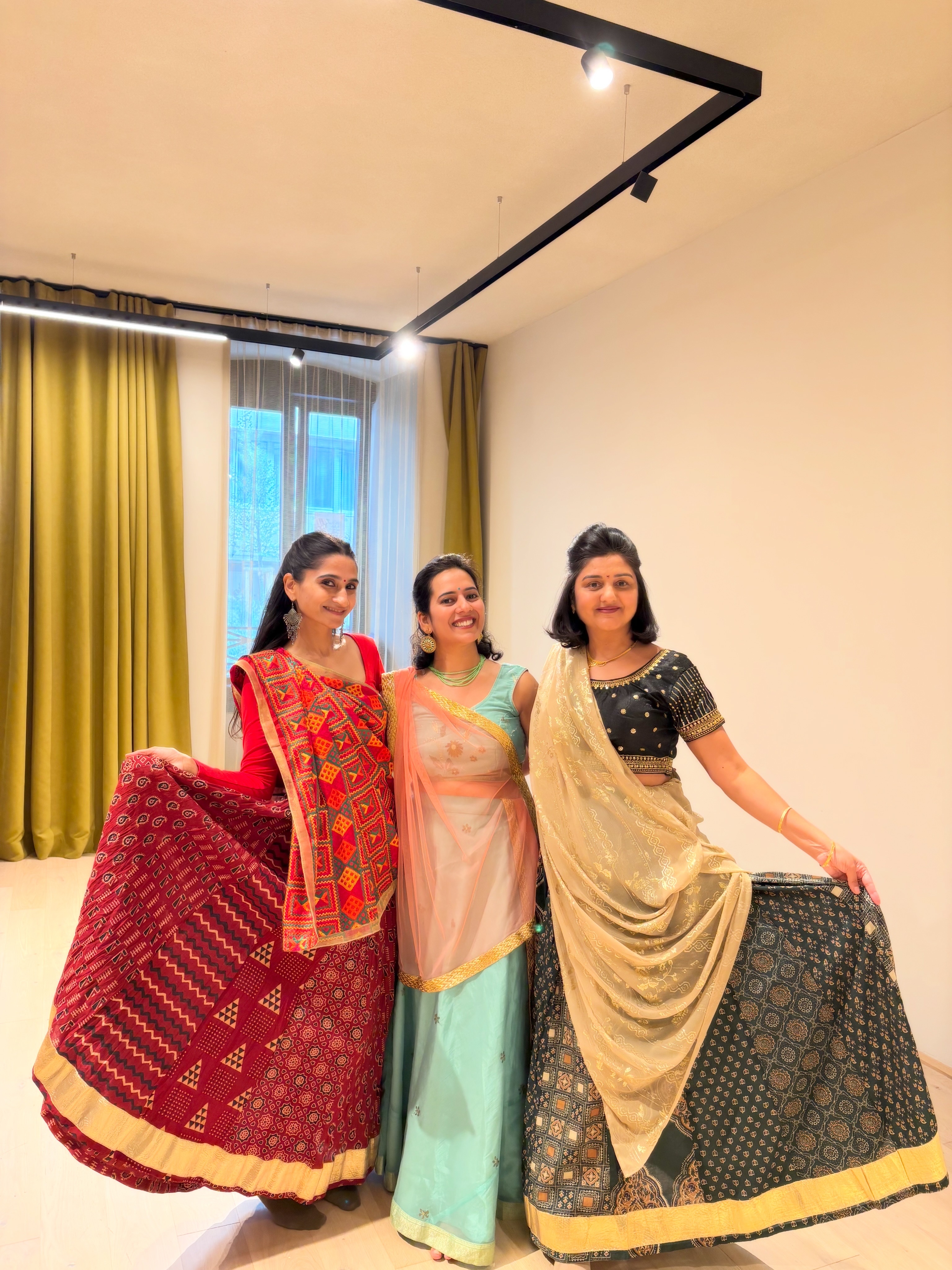 Participants pose with dandiya sticks after the Sur-Raas-Taal workshop